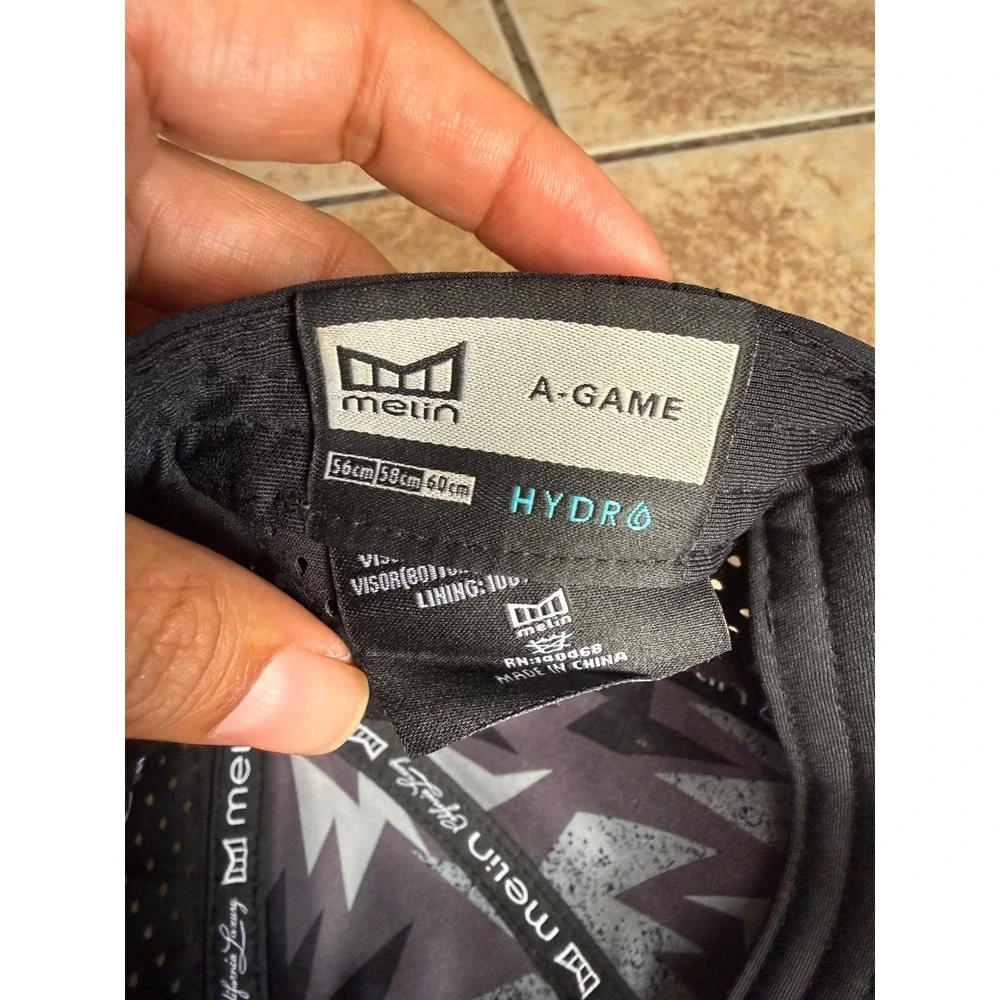 Melin A-Game Hydro Black Performance Snapback Hat 60cm L/XL Water Resistant
